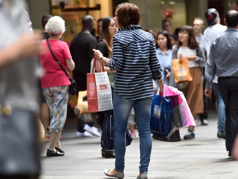  People carry their shopping bags through Sydney's Pitt Street Mall on December 2, 2015, as Australia's economy grew 0.9 percent in the third quarter for an annual rate of 2.5 percent, official data showed, with Treasurer Scott Morrison hailing progress in shifting from the resources boom to broader-based growth.  The September quarter numbers were slightly above analyst expectations and an improvement on the previous quarter's sluggish growth, which was revised to 0.3 percent by the Australian Bureau of Statistics.  AFP PHOTO / William WEST  