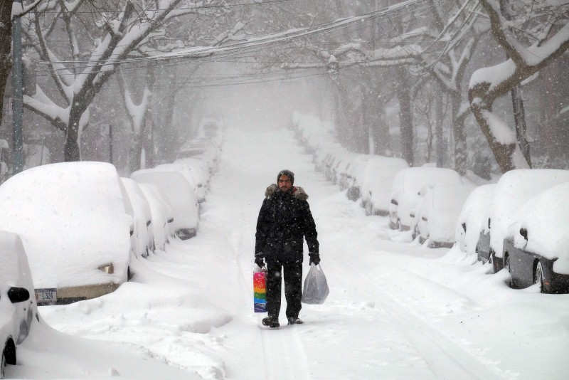 TOPSHOT - A MAN MAKES HIS WAY DURING A STORM IN NEW YORK ON JANUARY 23, 2016. A DEADLY BLIZZARD WALLOPED THE EASTERN US ON JANUARY 23, PARALYZING THE CAPITAL AND OTHER CITIES UNDER A HEAVY BLANKET OF SNOW AS OFFICIALS WARNED MILLIONS OF PEOPLE TO REMAIN INDOORS UNTIL THE STORM EASES UP. AT LEAST EIGHT PEOPLE WERE KILLED IN THREE STATES IN ROAD ACCIDENTS, OFFICIALS SAID, AS SNOW PILED UP FROM ARKANSAS TO NEW YORK. FORECASTERS SAID THE STORM -- DUBBED "SNOWZILLA" -- WOULD LAST INTO SUNDAY AS IT MOVED MENACINGLY UP THE COAST.  / AFP / JEWEL SAMAD  