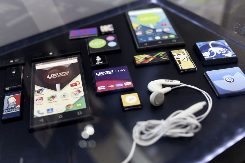  THE MOBILE DEVICE "ARA" BY YEZZ IS DISPLAYED WITH OTHER GADGETS DURING THE 2015 MOBILE WORLD CONGRESS (MWC) IN BARCELONA ON MARCH 3, 2015. PHONE MAKERS WILL SEEK TO SEDUCE NEW BUYERS WITH EVEN SMARTER INTERNET-CONNECTED WATCHES AND OTHER WIRELESS GADGETS AS THEY WRESTLE FOR DOMINANCE AT THE WORLD'S BIGGEST MOBILE FAIR. AFP PHOTO / JOSEP LAGO  