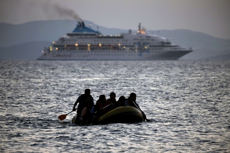  TOPSHOTS  MIGRANTS ARRIVE ON THE SHORE OF KOS ISLAND ON A SMALL DINGHY ON AUGUST 19, 2015. AUTHORITIES ON THE ISLAND OF KOS HAVE BEEN SO OVERWHELMED THAT THE GOVERNMENT SENT A FERRY TO SERVE AS A TEMPORARY CENTRE TO ISSUE TRAVEL DOCUMENTS TO SYRIAN REFUGEES -- AMONG SOME 7,000 MIGRANTS STRANDED ON THE ISLAND OF ABOUT 30,000 PEOPLE. THE UN REFUGEE AGENCY SAID IN THE LAST WEEK ALONE, 20,843 MIGRANTS -- VIRTUALLY ALL OF THEM FLEEING WAR AND PERSECUTION IN SYRIA, AFGHANISTAN AND IRAQ -- ARRIVED IN GREECE, WHICH HAS SEEN AROUND 160,000 MIGRANTS LAND ON ITS SHORES SINCE JANUARY, ACCORDING TO THE UN REFUGEE AGENCY.  AFP PHOTO / ANGELOS TZORTZINIS  