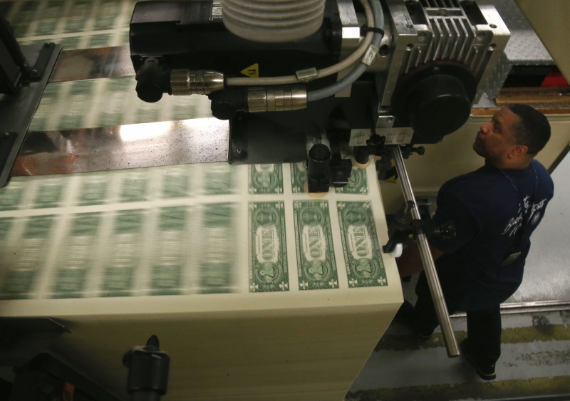  WASHINGTON, DC - MARCH 24: PRINTER EUGENE TURNER RUNS A PRESS THAT IS PRINTING ONE DOLLAR BILLS AT THE BUREAU OF ENGRAVING AND PRINTING ON MARCH 24, 2015 IN WASHINGTON, DC. THE ROOTS OF THE BUREAU OF ENGRAVING AND PRINTING CAN BE TRACED BACK TO 1862, WHEN A SINGLE ROOM WAS USED IN THE BASEMENT OF THE MAIN TREASURY BUILDING BEFORE MOVING TO ITS CURRENT LOCATION ON 14TH STREET IN 1864. THE WASHINGTON PRINTING FACILITY HAS BEEN RESPONSIBLE FOR PRINTING ALL OF THE PAPER FEDERAL RESERVE NOTES UP UNTIL 1991 WHEN IT SHARED THE PRINTING RESPONSIBILITIES WITH A NEW WESTERN FACILITY THAT OPENED IN FORT WORTH, TEXAS.   MARK WILSON/GETTY IMAGES/AFP  == FOR NEWSPAPERS, INTERNET, TELCOS &TELEVISION USE  