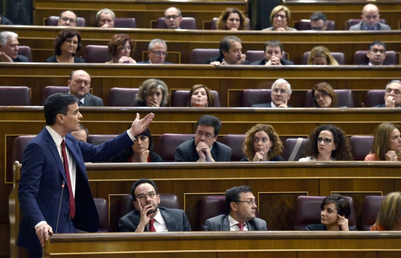  Leader of the Spanish Socialist Party (PSOE) and candidate for prime minister, Pedro Sanchez (L) speaks from his seat at Las Cortes in Madrid on March 2, 2016 during a parliamentary debate to vote through a prime minister and allow the country to finally get a government.  The parliamentary session is a key step towards trying to unblock nearly 11 weeks of political stalemate since inconclusive December elections resulted in a hung parliament divided among four main parties, none of which won enough seats to govern alone.  