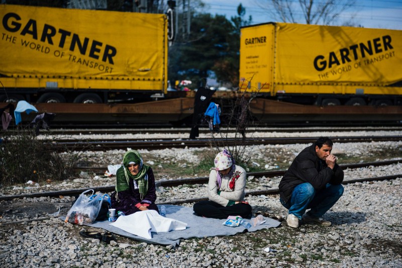 A FAMILY SITS NEAR TRACKS AT THE GREEK-MACEDONIAN BORDER NEAR THE GREEK VILLAGE OF IDOMENI, ON MARCH 6, 2016, WHERE THOUSANDS OF MIGRANT AND REFUGEES WAIT TO CROSS THE BORDER INTO MACEDONIA.  GREECE IS LIKELY TO RECEIVE ANOTHER 100,000 MIGRANTS BY THE END OF THE MONTH, EUROPE'S MIGRATION COMMISSIONER WARNED ON MARCH 6, 2016, TWO DAYS AHEAD OF AN EU-TURKEY SUMMIT SEEN AS THE ONLY VIABLE SOLUTION TO THE CRISIS. / AFP / DIMITAR DILKOFF  