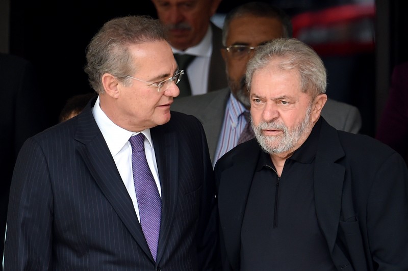  Former Brazilian President Luiz Inácio Lula da Silva (R) and Senate President Renan Calheiros talk after having a breakfast meeting at the latter's residence in Brasilia, on March 9, 2016. Lula da Silva is facing allegations of taking bribes and laundering money from Petrobras-connected companies. On March 4 he was briefly detained for questioning over alleged 