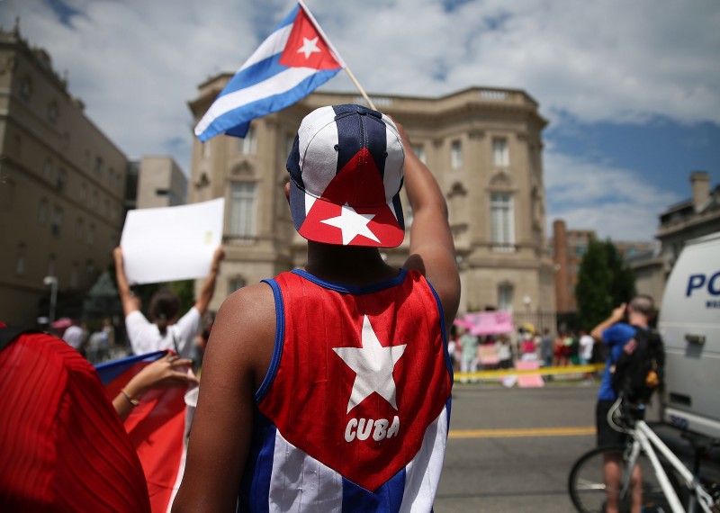  WASHINGTON, DC - JULY 20: CUBAN SUPPORTER DANIAL ESPINO DELGADO WAVES A CUBAN FLAG IN FRONT OF THE COUNTRY'S EMBASSY AFTER IT RE-OPENED FOR THE FIRST TIME IN 54 YEARS JULY 20, 2015 IN WASHINGTON, DC. THE EMBASSY WAS CLOSED IN 1961 WHEN U.S. PRESIDENT DWIGHT EISENHOWER SEVERED DIPLOMATIC TIES WITH THE ISLAND NATION AFTER FIDEL CASTRO TOOK POWER IN A COMMUNIST REVOLUTION.   MARK WILSON/GETTY IMAGES/AFP  == FOR NEWSPAPERS, INTERNET, TELCOS &TELEVISION USE ONLY ==  