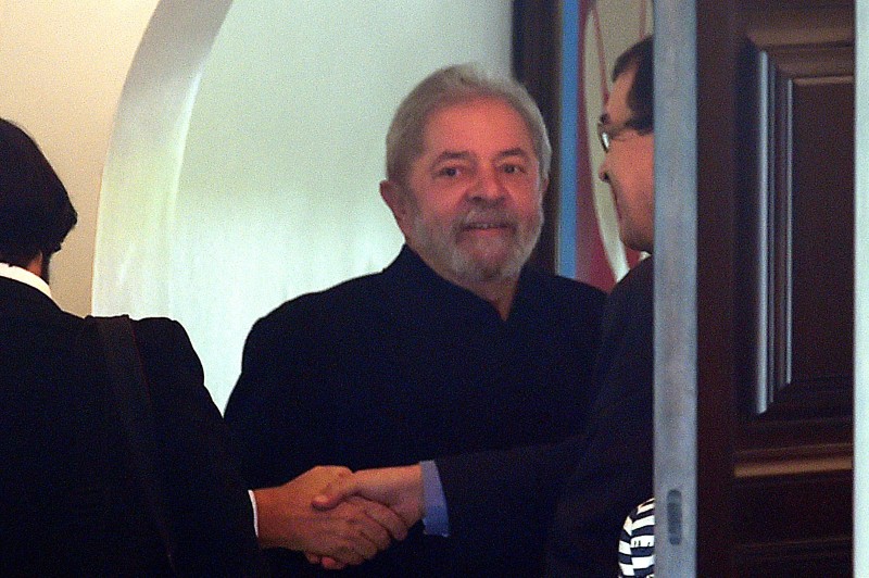  Former Brazilian President Luiz Inácio Lula da Silva leaves after having a breakfast meeting with senators from several parties at the residence of Senate President Renan Calheiros, in Brasilia, on March 9, 2016. Lula da Silva is facing allegations of taking bribes and laundering money from Petrobras-connected companies. On March 4 he was briefly detained for questioning over alleged "favours" received from corrupt construction companies implicated in a kickback scheme, prosecutors said. Lula da Silva was targeted as part of the Operation Car Wash investigation into a sprawling embezzlement and bribery conspiracy centred on the state oil giant Petrobras.  AFP PHOTO/EVARISTO SA  
