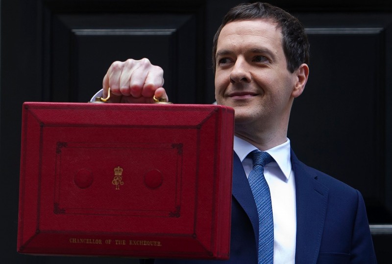  British Finance Minister George Osborne poses for pictures with the Budget Box as he leaves 11 Downing Street in London, on March 16, 2016, before presenting the government's annual budget to parliament.  British finance minister George Osborne will unveil Wednesday his annual budget, with more austerity pain as the global economic outlook darkens, but will pledge more cash for education and infrastructure.Most economists believe Chancellor of the Exchequer Osborne will likely avoid any major shocks, with three months to go until Britons vote on EU membership in a crucial referendum.   / AFP PHOTO / JUSTIN TALLIS  