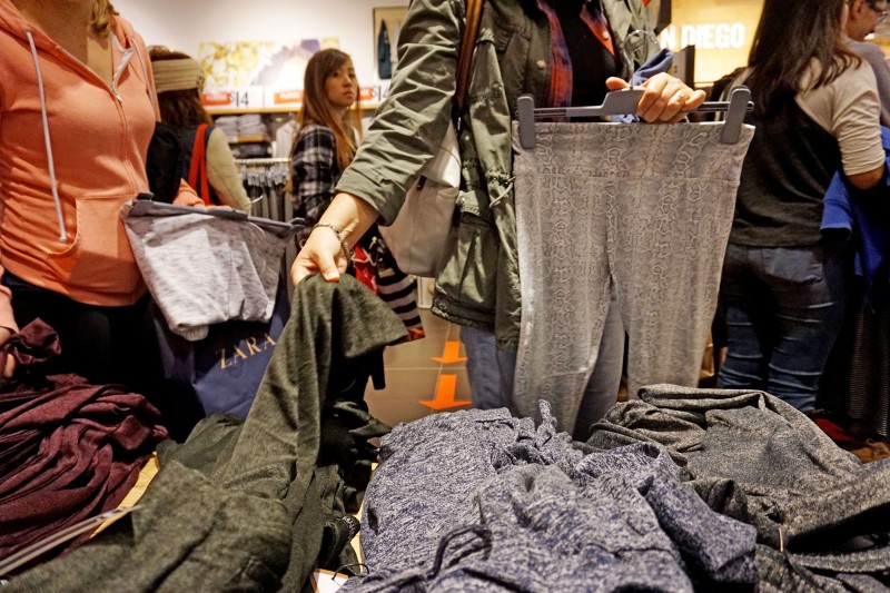  SAN DIEGO, CA - NOVEMBER 27: Holiday shoppers peruse through clothing items at Fashion Valley Mall on November 27, 2015 in San Diego, California. Although Black Friday sales are expected to be strong, many shoppers are opting to buy online or retailers are offering year round sales and other incentives that are expected to ease crowds.( Photo by Sandy Huffaker/Getty Images/AFP  == FOR NEWSPAPERS, INTERNET, TELCOS &TELEVISION USE ONLY ==  