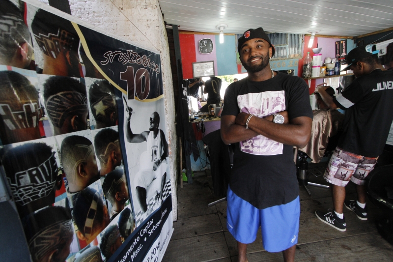 Desempregado, Lennon come&ccedil;ou a fazer desenhos na cabe&ccedil;a do filho. Hoje, atende cerca de 50 pessoas por dia Foto: MARCELO G. RIBEIRO/JC