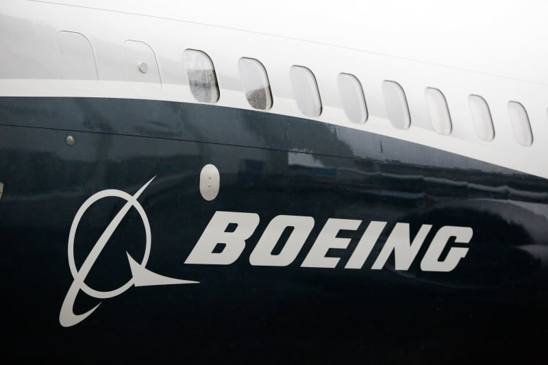 (FILES) In this file photo taken on March 7, 2017 The Boeing logo on the Boeing 737 MAX 9 airplane is pictured during its rollout for media at the Boeing factory in Renton, Washington. 
Boeing and Embraer are close to an agreement to combine their commercial air operations into a new company, a person familiar with the talks told AFP on February 6, 2018. Boeing would hold 80 to 90 percent of the new company, which would be based in Chicago. Embraer's military operations would not be affected by the transaction and would remain under Brazilian control, the person said.  / AFP PHOTO / Jason Redmond