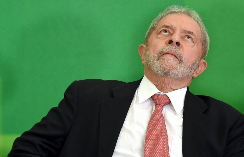 POL LUIZ INÁCIO LULA DA SILVA
(FILES) In this file photo taken on March 17, 2016 former Brazilian president Luiz Inacio Lula da Silva gestures next to Brazilian president Dilma Rousseff (out of frame) after Lula's sworn in as chief of staff, in Brasilia on March 17, 2016. 
Brazil's former president and current election frontrunner Luiz Inacio Lula da Silva looked increasingly likely to face prison on April 04, 2018  after five out of eleven judges of the divided Supreme Court voted against allowing him to delay a sentence for corruption. / AFP PHOTO / EVARISTO SA