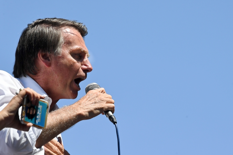 Brazilian right-wing presidential candidate Jair Bolsonaro speaks to supporters during a campaign rally in the district of Ceilandia in Brasilia, on September 5, 2018. - Brazil will hold presidential elections on October 7. (Photo by EVARISTO SA / AFP)
      Caption