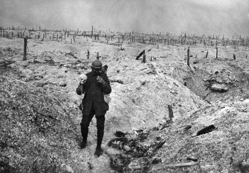 Soldado francês segura um crânio em um campo de batalha da Primeira Guerra Mundial