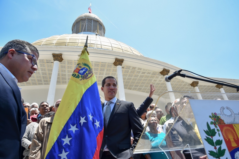 Venezuelan opposition leader and self-proclaimed interim president Juan Guaido leaves after a press conference at the National Assembly building in Caracas for a meeting with civil servants on April 8, 2019. - Venezuelan opposition leader Juan Guaido on Saturday launched what he promised will be a 
