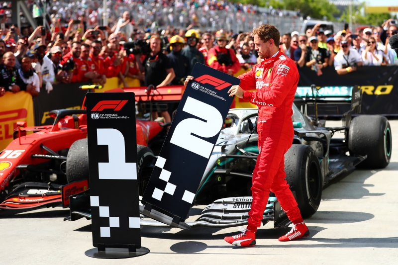 MONTREAL, QC - JUNE 09: Second placed Sebastian Vettel of Germany and Ferrari swaps the number boards at parc ferme during the F1 Grand Prix of Canada at Circuit Gilles Villeneuve on June 09, 2019 in Montreal, Canada.   Dan Istitene/Getty Images/AFP