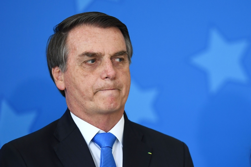 Brazilian President Jair Bolsonaro is pictured during the commemoration ceremony of the National Volunteer Day, at Planalto Palace in Brasilia, on August 28, 2019. - Bolsonaro on Wednesday repeated a demand for French leader Emmanuel Macron to withdraw recent remarks, as he accused France and Germany of 