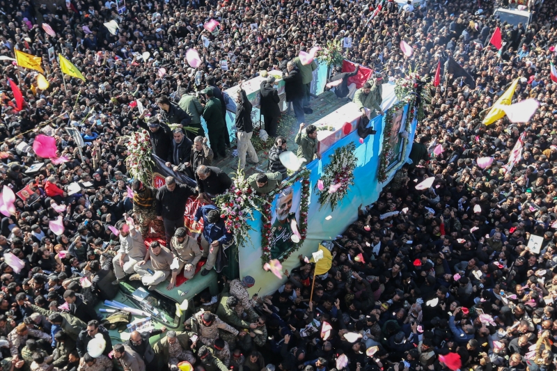 Iranian mourners gather around a vehicle carrying the coffin of slain top general Qasem Soleimani during the final stage of funeral processions, in his hometown Kerman on January 7, 2020. - Soleimani was killed outside Baghdad airport Friday in a drone strike ordered by US President Donald Trump, ratcheting up tensions with arch-enemy Iran which has vowed 