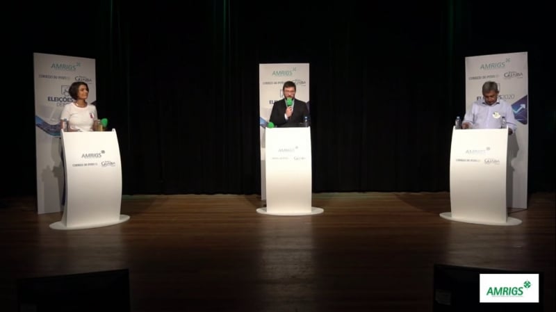 Manuela d'Ávila (E) e Sebastião Melo (D) atacaram posicionamentos de adversário em debate da Rádio Guaíba, em parceria com a Amrigs.