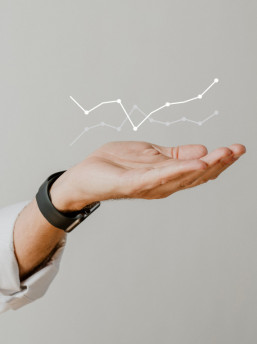 Digital graph performance with businessman hand overlay