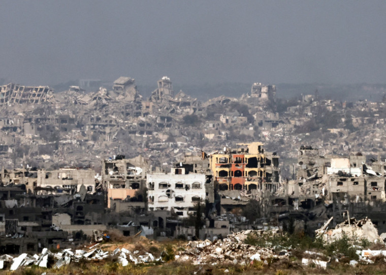  This picture taken from the Israeli side of the border with the Gaza Strip shows destroyed buildings in northern Gaza on January 16, 2025, following the announcement of a truce amid the ongoing war between Israel and Hamas. Israel's cabinet was expected to meet on January 16, to approve a ceasefire and hostage-release deal with Hamas, Israeli media reported, a day after mediators announced an agreement they hope will lead to a permanent end to the Gaza war. (Photo by Menahem KAHANA / AFP)