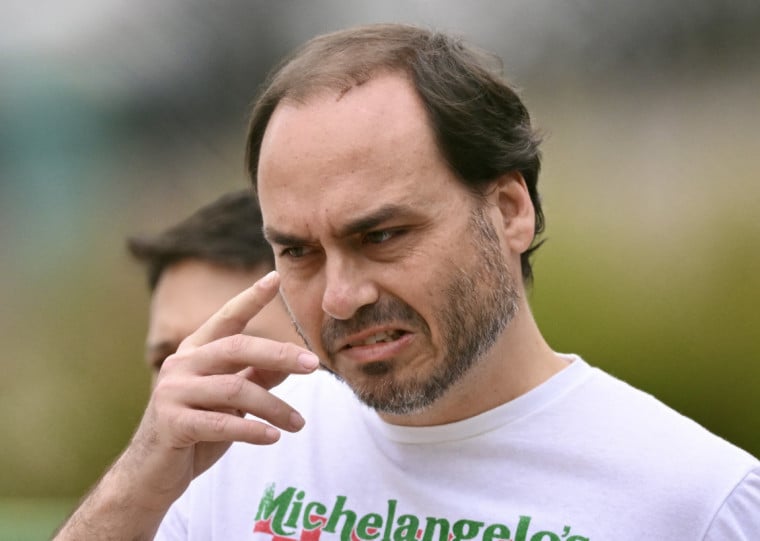  Rio de Janeiro's Councillor, Carlos Bolsonaro, son of former Brazilian President Jair Bolsonaro, leaves the Federal Police headquarters where his father is being held, in Brasilia, on November 25, 2025. Brazil's Supreme Court on November 24 voted to uphold the imprisonment of former president Jair Bolsonaro, who was detained over the weekend for tampering with his ankle monitor using a soldering iron. (Photo by Evaristo SA / AFP)