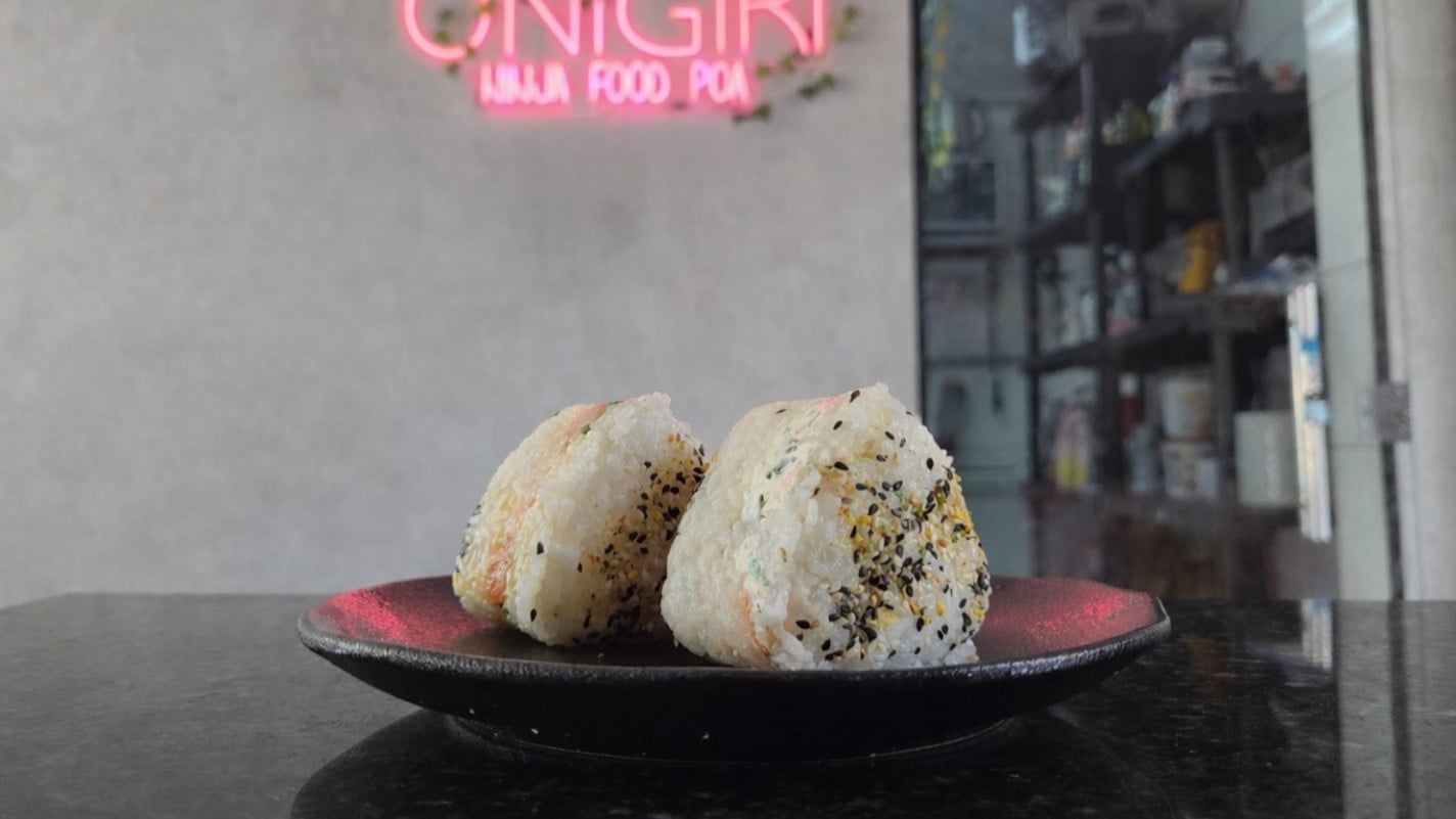 O onigiri &eacute; um bolinho de arroz japon&ecirc;s, geralmente em forma de tri&acirc;ngulo, envolto por uma folha de nori e recheado com frutos do mar | Gustavo Marchant/Especial/JC