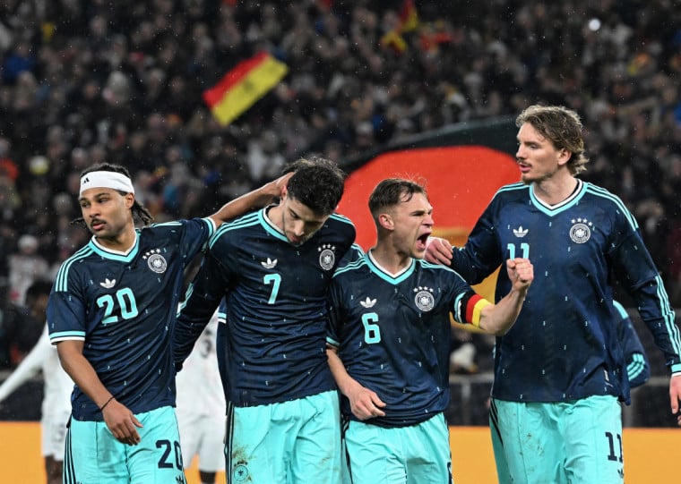  (From L) Germany's midfielder #20 Serge Gnabry, Germany's forward #07 Kai Havertz, Germany's defender #06 Joshua Kimmich and Germany's forward #11 Nick Woltemade  celebrate their team's first goal scored by Havertz during the international friendly football match between Germany and Ghana in Stuttgart, southwestern Germany on March 30, 2026. (Photo by THOMAS KIENZLE / AFP)