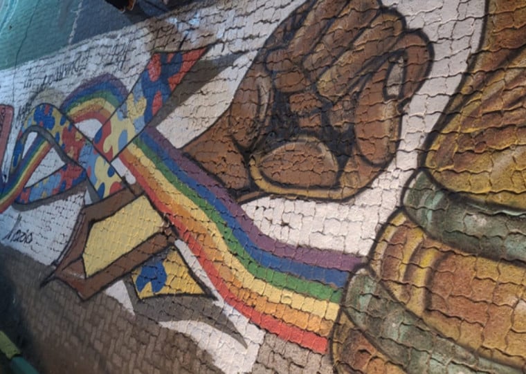 Pintura tem simbolos da conscientização ao autismo misturados a desenhos em comemoração a Copa do Mundo