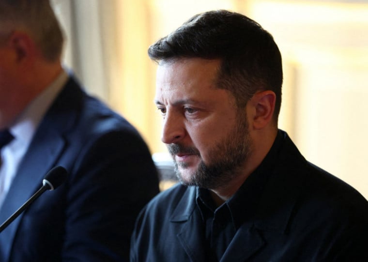  Ukraine's President Volodymyr Zelensky (C) looks on at the start of the Integrated Anti-Ballistic Missile Coalition meeting ahead of a summit of the Coalition of the Willing to support Ukraine at the Hotel des Invalides in Paris on July 13, 2026. The summit meeting of the Coalition of the Willing -- launched by France and the United Kingdom to provide military support to Ukraine after Russia's full-scale invasion -- will push for a ceasefire and renewed peace talks, the French presidency said. (Photo by Tom Nicholson / POOL / AFP)